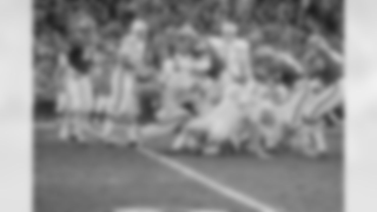 Miami's Jim Kiick (21) is hauled up by short Kansas City's Curley Culp (61) and Buck Buchanan (86) for no gain in the first quarter of the play-off game Dec. 25, 1971 in Kansas City. (Associated Press)