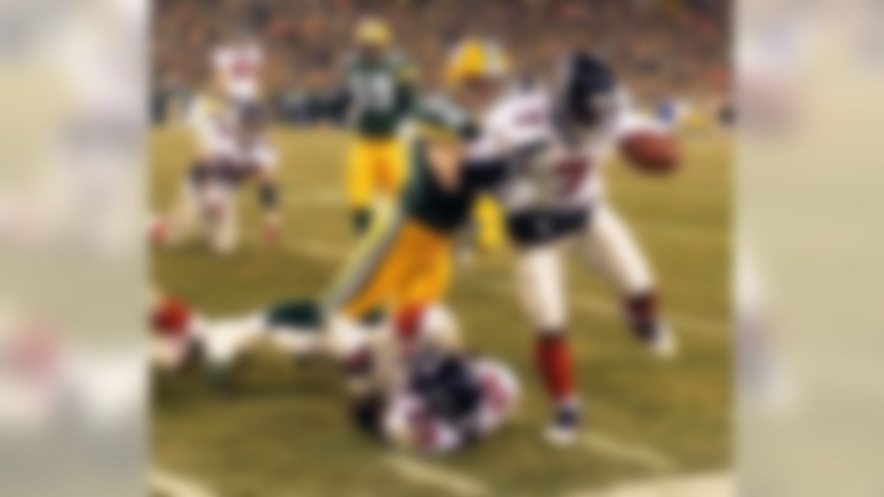 Green Bay Packers' safety Matt Bowen (28) knocks Atlanta Falcons' quarterback Michael Vick (7) out of bounds on a run in the first quarter of their NFC Wildcard game Saturday, Jan. 4, 2003, in Green Bay, Wis. (AP Photo/Morry Gash)