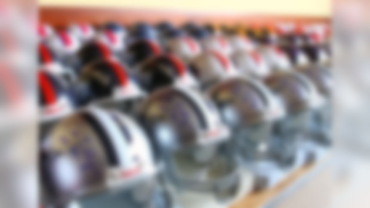 Helmets signed by Hall of Famer Bob Lilly are seen at the McKinley Grand Hotel in Canton, Ohio on August 3, 2012. (AP Photo/Ben Liebenberg)