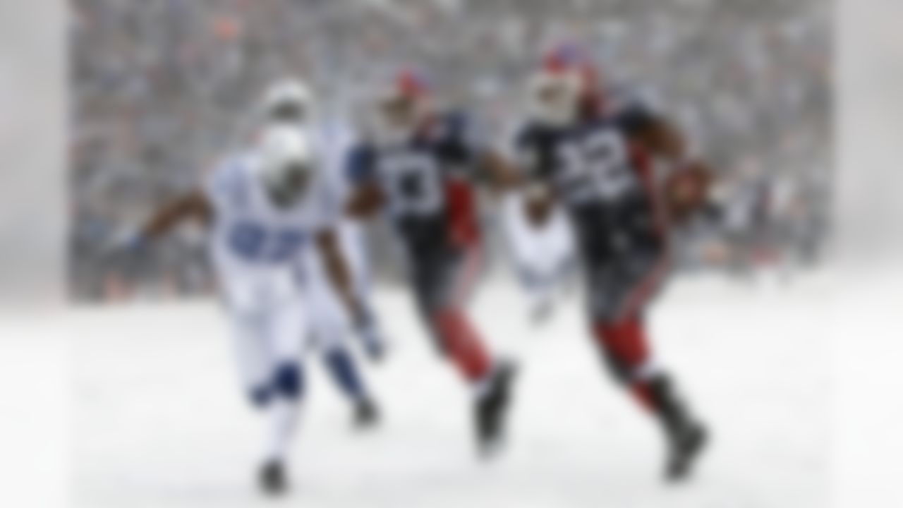 Buffalo Bills' Fred Jackson (22) runs under pressure from Indianapolis Colts' Jacob Lacey (27) during the first half of the NFL football game in Orchard Park, N.Y., Sunday, Jan. 3, 2010. (AP Photo/ David Duprey)