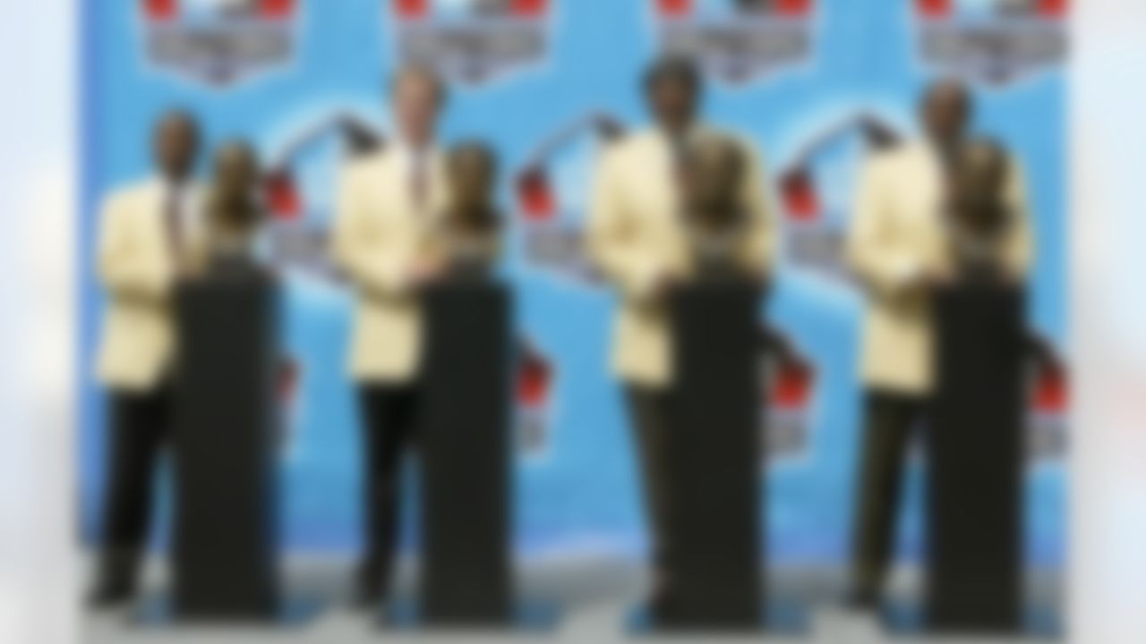 Barry Sanders, John Elway, Carl Eller, and Bob Brown, from left to right, pose with his busts after their induction into the Pro Football Hall of Fame Sunday, Aug. 8, 2004, in Canton, Ohio. (AP Photo/Ron Schwane)
