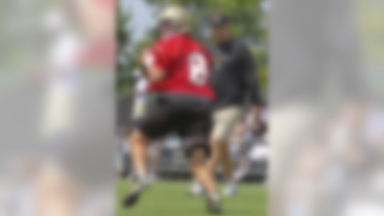 New Orleans Saints coach Sean Payton keeps a close eye on quarterback Drew Brees (9) during the morning practice session at the club's NFL football training facility in Metairie, Saturday, June 5, 2010. (AP Photo/Bill Haber)