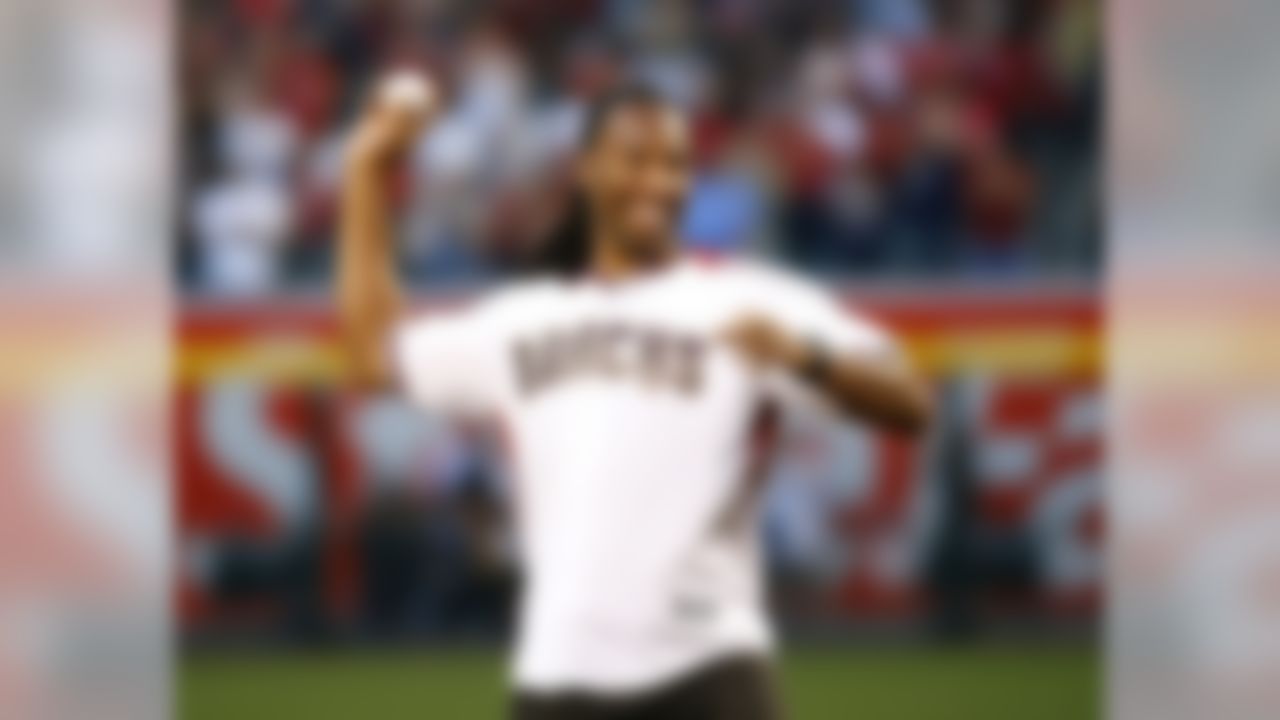 Arizona Cardinals wide receiver Larry Fitzgerald throws out the ceremonial first pitch prior to a baseball game between the Colorado Rockies and the Arizona Diamondbacks, Monday, April 4, 2016, in Phoenix. (AP Photo/Matt York)