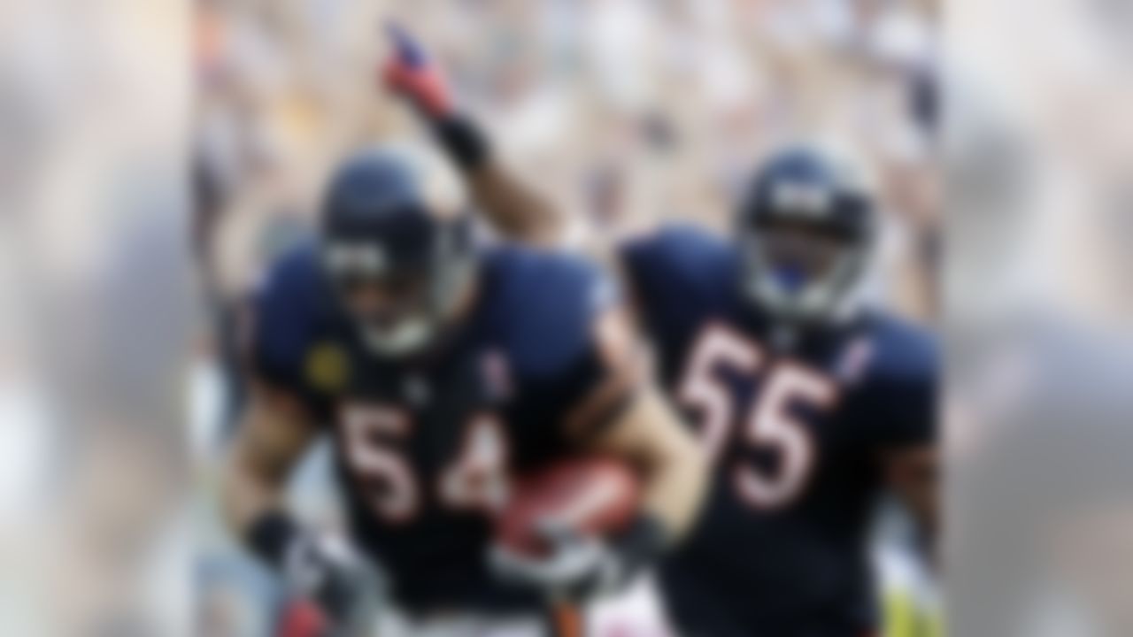 Chicago Bears linebacker Brian Urlacher (54) runs 12 yards for a touchdown after a fumble recovery against the Atlanta Falcons in the second half of an NFL football game in Chicago, Sunday, Sept. 11, 2011. Bears' Lance Briggs, right, celebrates. (AP Photo/Nam Y. Huh)