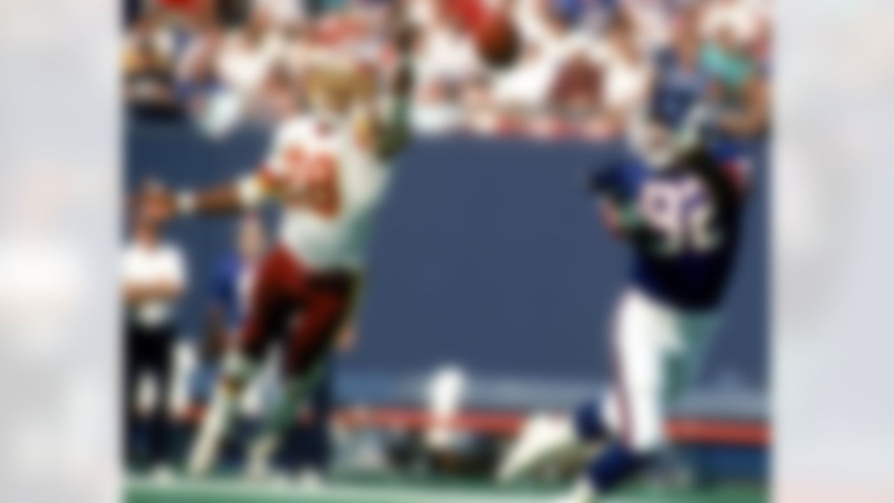 EAST RUTHERFORD, NJ - OCTOBER 15: Wide receiver Mark Ingram #82 of the New York Giants reaches for a pass beyond the outstretched hands of cornerback Darrell Green #28 of the Washington Redskins at Giants Stadium on October 15, 1989 in East Rutherford, New Jersey. The Giants defeated the Redskins 20-17. (Photo by Jim Turner/NFL Photos)
