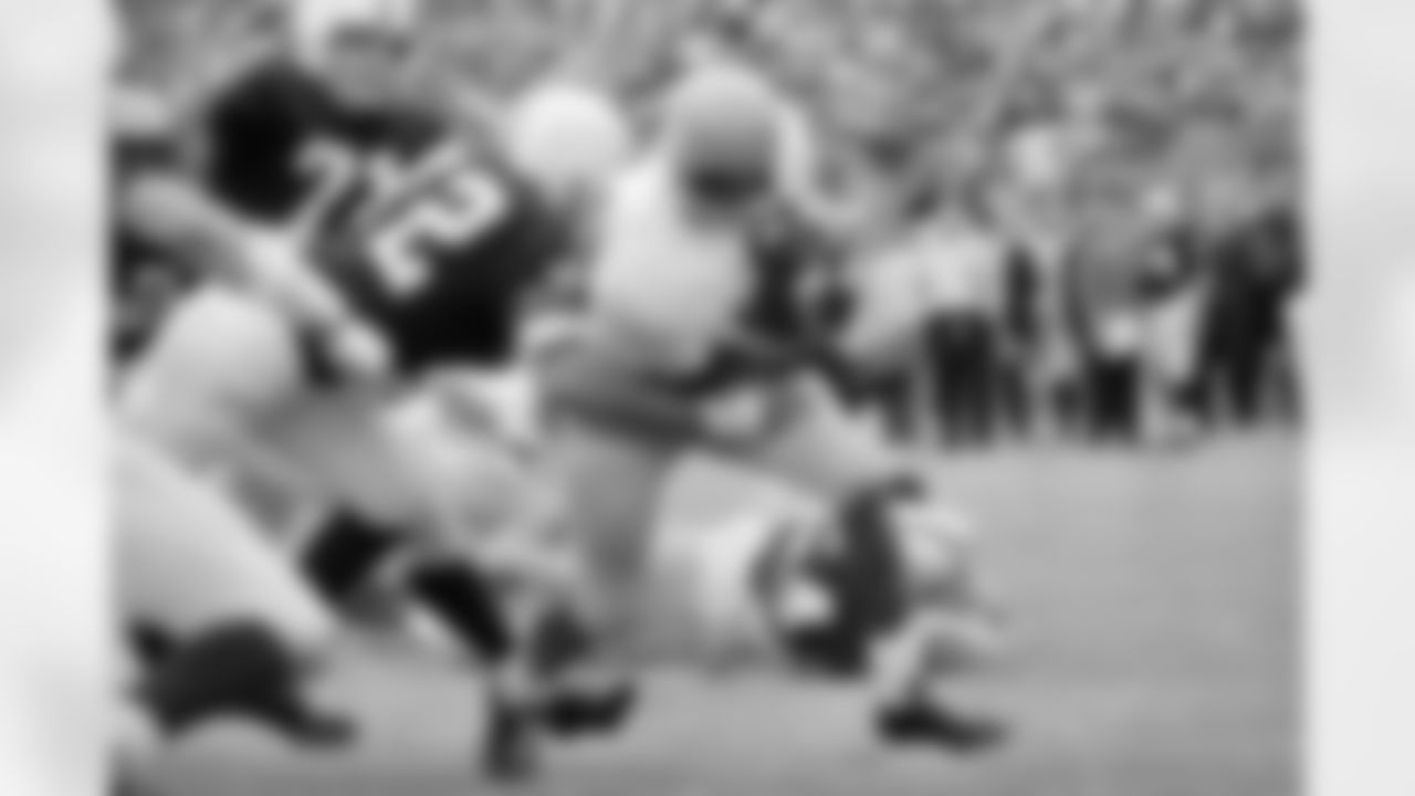 Kansas University's Gale Sayers scores for the Jayhawks in the first quarter of the Kansas-Kansas state game at Manhattan. At left, Kansas State's Ken Nash (72) moves in for the tackle. (AP Photo/William Straeter)