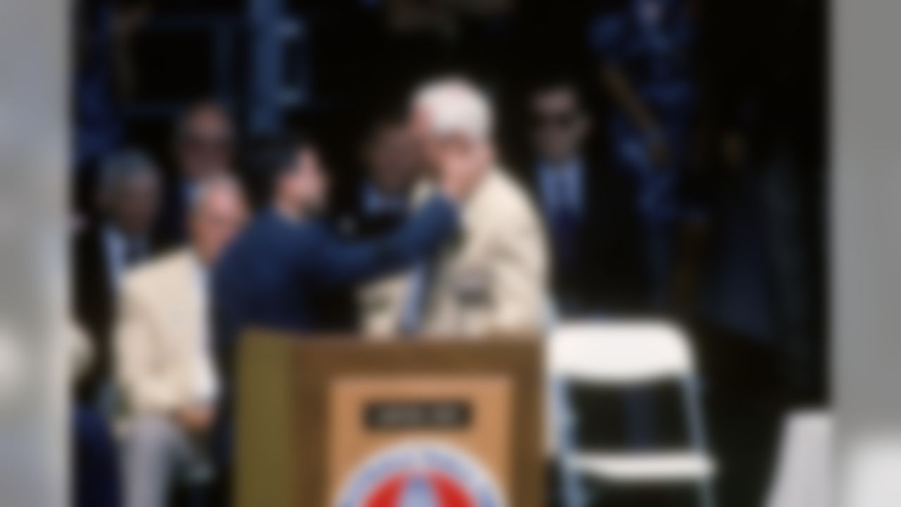 Coach Bill Walsh is embraced by San Francisco 49ers owner Eddie DeBartolo after his induction into the Pro Football Hall of Fame on July 31, 1993 at Fawcett Stadium in Canton, Ohio. (National Football League)