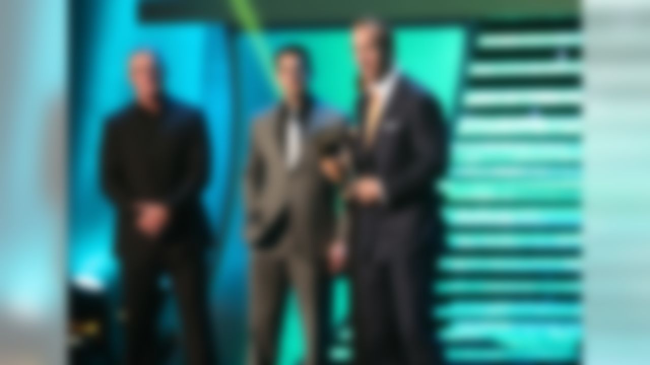 Denver Broncos quarterback Peyton Manning, right, accepts the AP Comeback Player of the Year award as former Green Bay Packers quarterback Brett Favre and Packers quarterback Aaron Rodgers look on during the 2nd Annual NFL Honors awards show at the Mahalia Jackson Theatre on Saturday, February 2, 2013 in New Orleans, LA. (Ben Liebenberg/NFL)