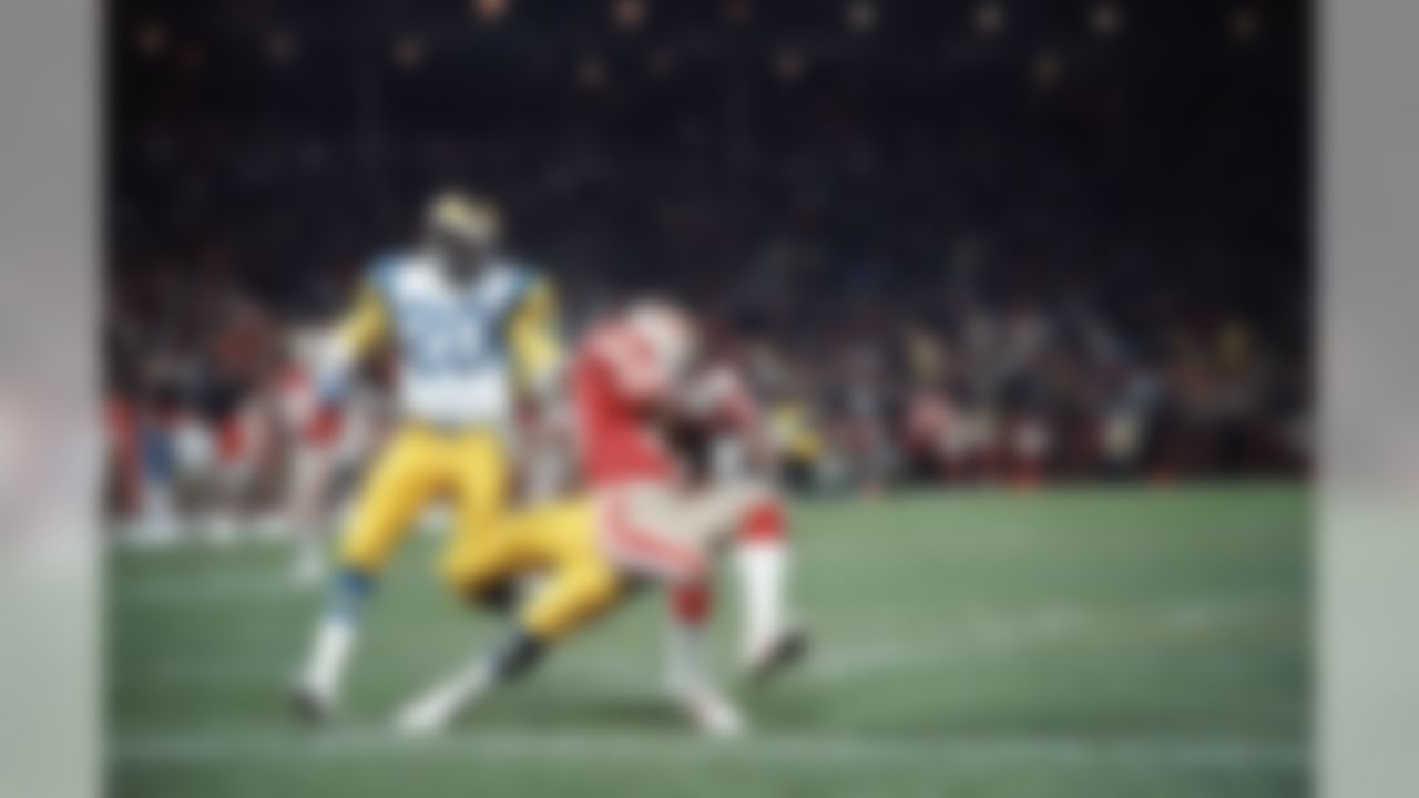 San Francisco 49ers wide receiver Jerry Rice (80) wrestles pass away from Los Angeles Rams safety Nolan Cromwell (21) for a 49ers touchdown in the first quarter of game on Friday, Dec. 19, 1986 in San Francisco, as Rams safety Johnnie Johnson (20) watches. Rice scored on a 44-yard pass from quarterback Joe Montana. (AP Photo/Paul Sakuma)