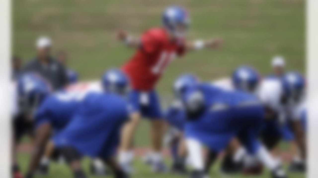 New York Giants quarterback Eli Manning (10) calls a play during a practice at NFL football training camp in Albany, N.Y., Friday, July 27, 2012. (AP Photo/Kathy Willens)