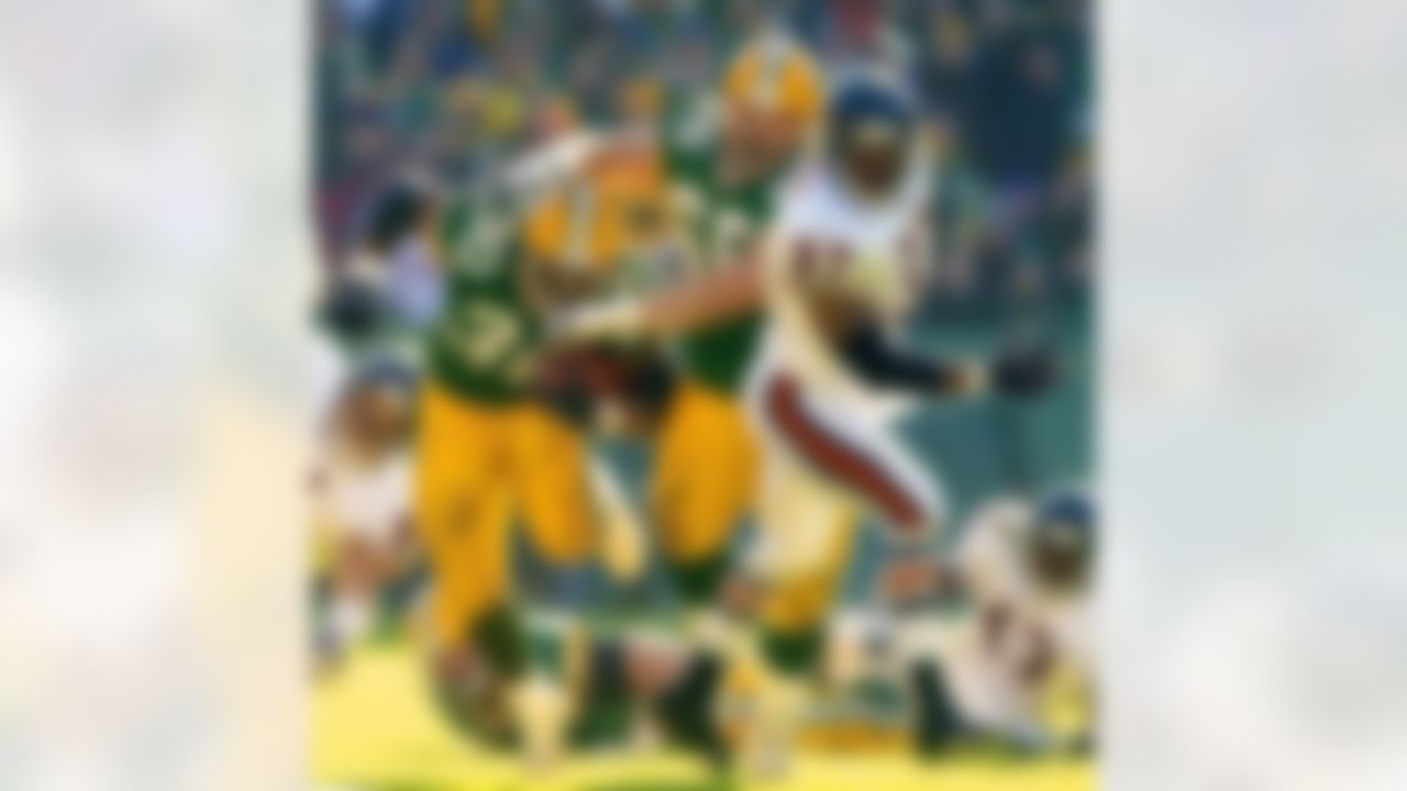 Green Bay Packers' tackle Mark Tauscher (65) runs into running back Ahman Green (30) as he blocks Chicago Bears' safety Tony Parrish (37) during the second quarter Sunday, Dec. 9, 2001, in Green Bay, Wis. (AP Photo/Morry Gash)
