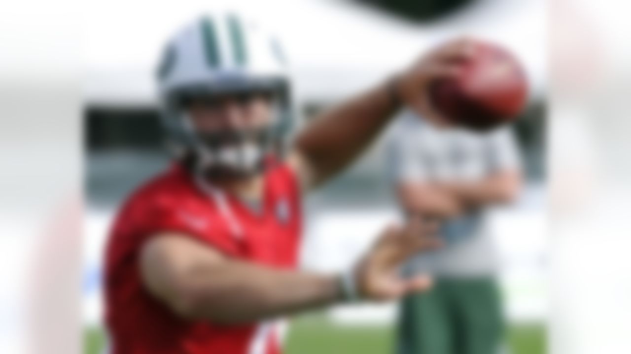 New York Jets quarterback Tim Tebow looks for a receiver on opening day of their NFL football training camp Friday, July 27, 2012 in Cortland, N.Y. (AP Photo/Bill Kostroun)