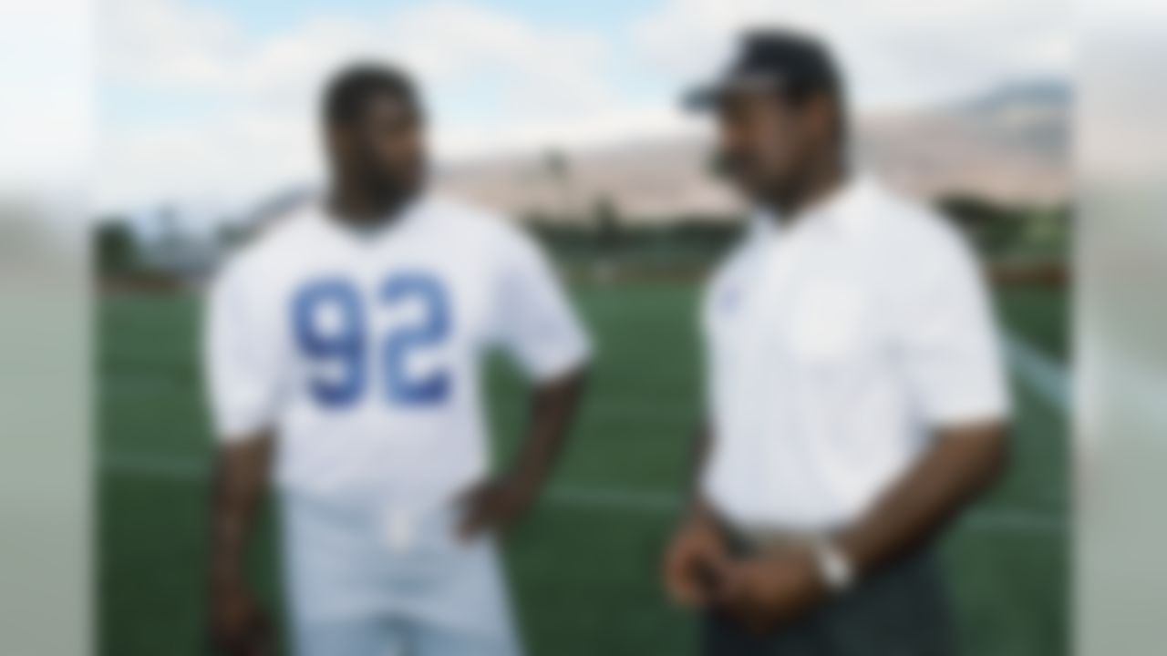 NFC Green Bay Packers defensive end Reggie White (92) talks to NFL Players Association executive director (and member of the Pro Football Hall of Fame) Gene Upshaw after practice at the 1994 NFL Pro Bowl football game between the AFC and the NFC on February 6, 1994 in Ko Olina, Hawaii. The NFC won the game 17-3. (AP Photo/Paul Spinelli)