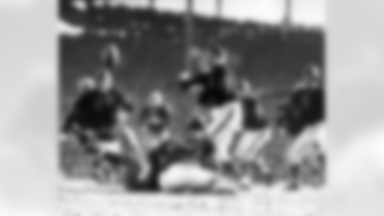 Chicago Bears Hall of Fame guard Danny Fortmann (21) and Bears end John Siegel (6) react to the ball after a tackle by Bears guard Ray Bray (82) in a 33 to 14 Green Bay Packers loss to the Chicago Bears in the 1941 Western Division Playoff game played at Wrigley Field on Dec. 14, 1941 in Chicago. (National Football League)