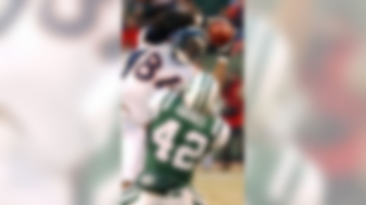 Denver Broncos tight end Shannon Sharpe catches a pass for a first down in the first quarter as he is defended by New York Jets safety Sam Garnes Sunday, Dec. 8, 2002 in East Rutherford, N.J. (AP Photo/Mark Lennihan)
