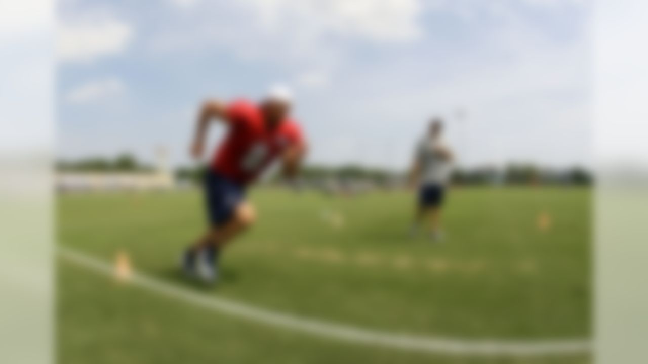 Tennessee Titans quarterback Matt Hasselbeck (8) goes through a drill with assistant strength coach Jason Noavak during NFL football camp at Titans' headquarters Monday, July 30, 2012 Nashville, Tenn. (AP Photo/Wade Payne)