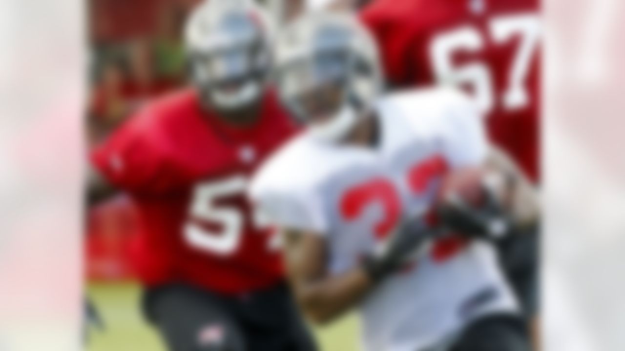 Tampa Bay Buccaneers running back Mossis Madu runs the ball during a workout at NFL football training camp, Saturday, July 28, 2012, in Tampa, Fla. (AP Photo/Mike Carlson)