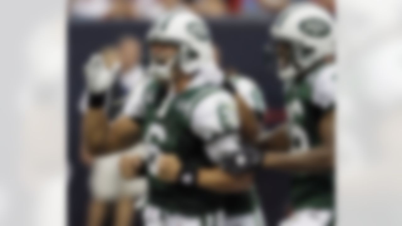 New York Jets quarterback Mark Sanchez (6) celebrates with teammates Dustin Keller (81), and Brad Smith (16) after throwing a 30-yard touchdown pass against the Houston Texans during the second quarter of a NFL football game Sunday, Sept. 13, 2009, in Houston. (AP Photo/David J. Phillip)