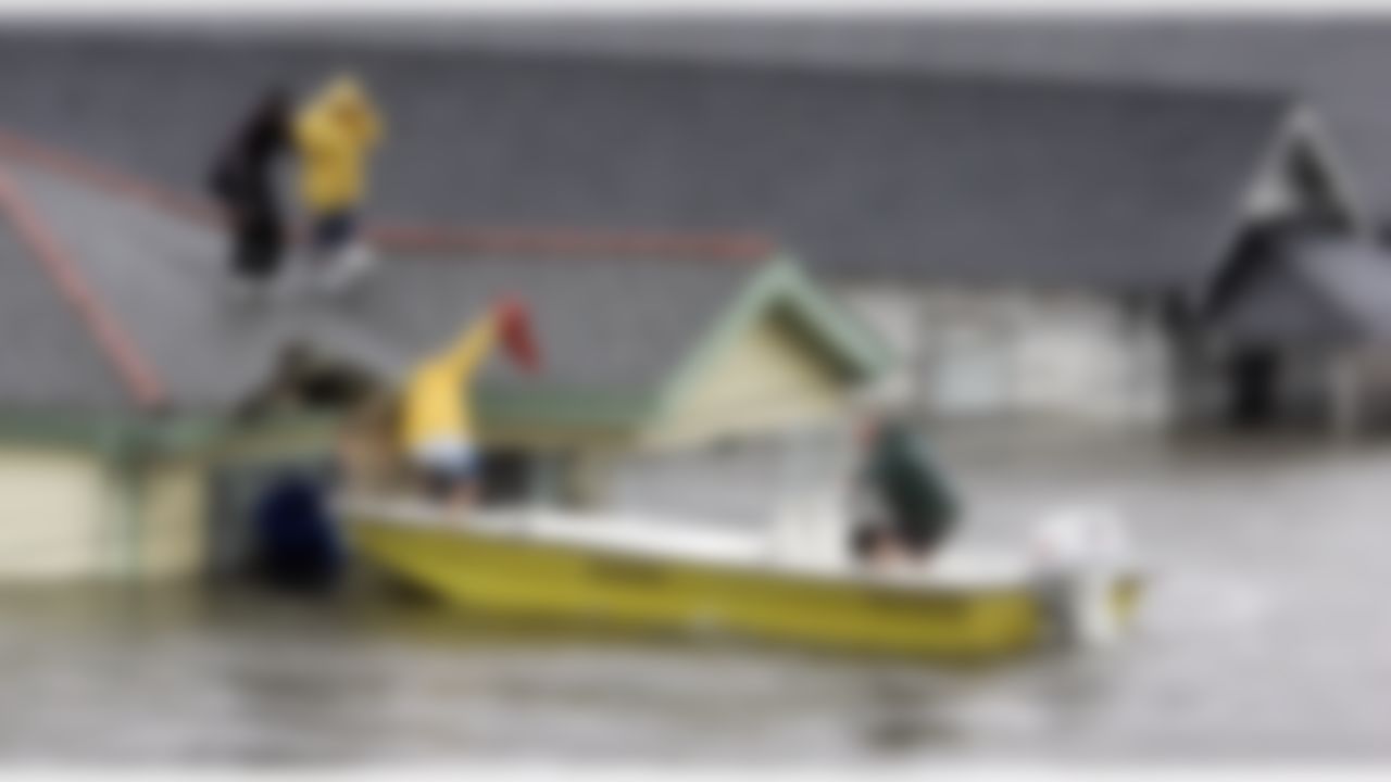 Residents are rescued from their rooftop in their New Orleans neighborhood on Monday, Aug. 29, 2005. Officials had called for a mandatory evacuation of the city, but many residents remained. (AP Photo/Eric Gay)