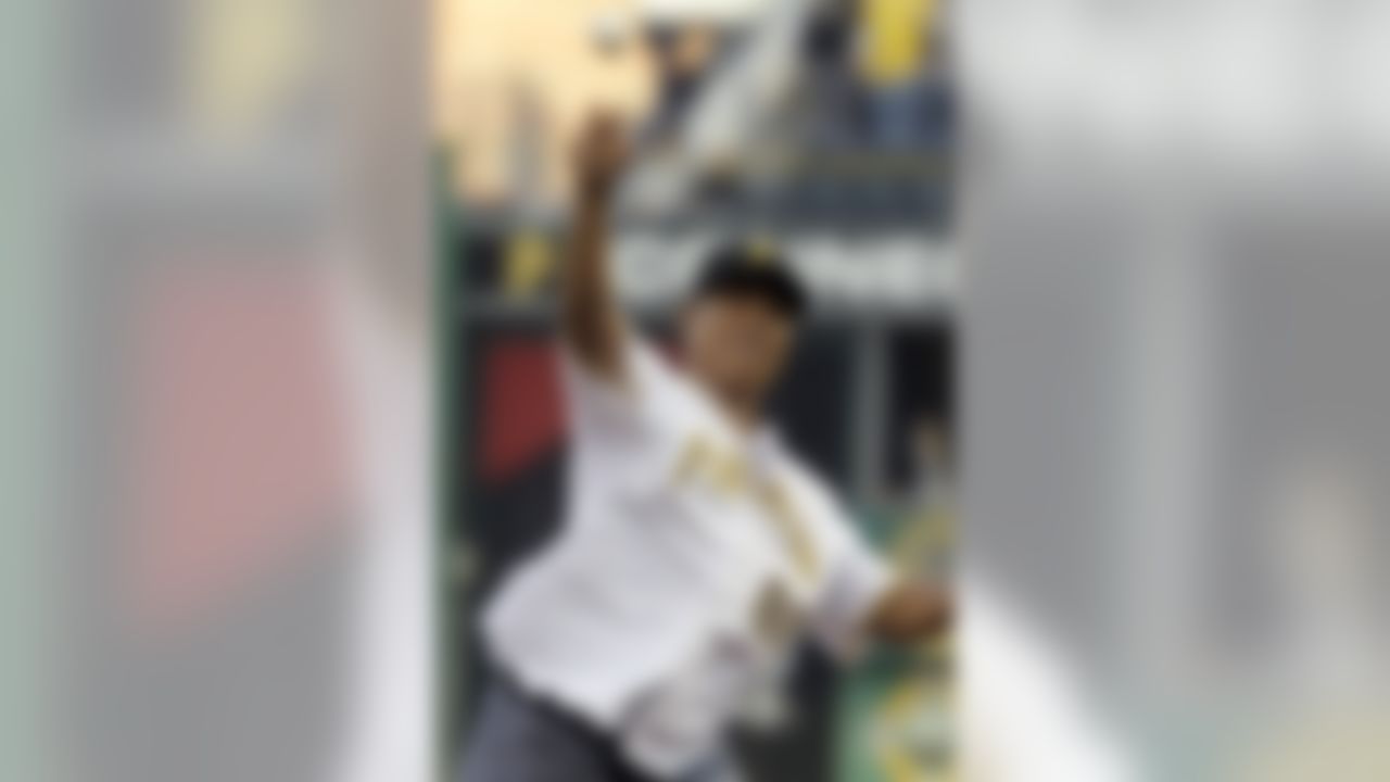 Retired Pittsburgh Steelers receiver Hines Ward throws out the ceremonial first pitch before a baseball game between the Pittsburgh Pirates and the Washington Nationals in Pittsburgh, Thursday, May 10, 2012. (AP Photo/Gene J. Puskar)
