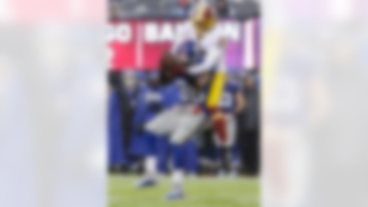 Washington Redskins cornerback DeAngelo Hall (23) deflects a pass to New York Giants' Hakeem Nicks (88) during the first half of an NFL football game Sunday, Dec. 29, 2013, in East Rutherford, N.J.