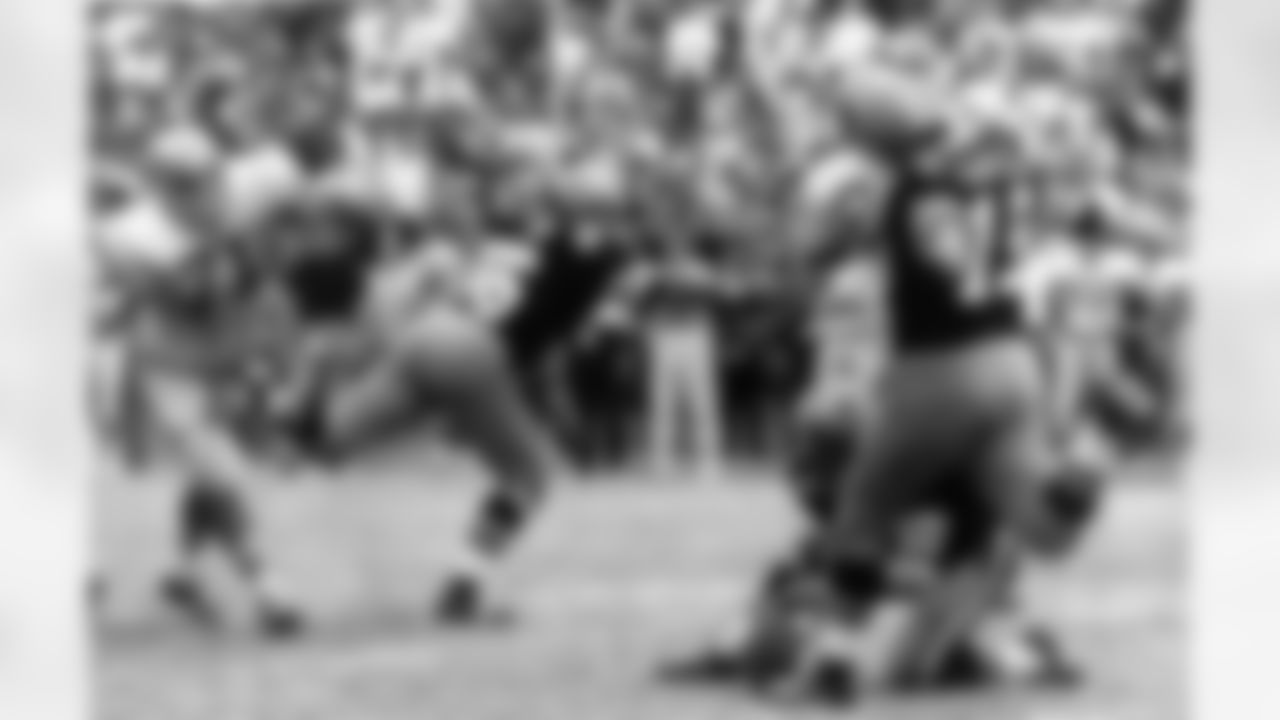 New Orleans Saints' Tom Dempsey (19) moves up to kick a 63-yard field goal as teammate Joe Scarpati holds the ball, Detroit Lions' Alex Karras (71) rushes in, and Saints' Bill Cody (66) blocks, in New Orleans. The record-setting kick, with 2 seconds left in the game, gave the Saints a 19-17 win. (AP Photo)