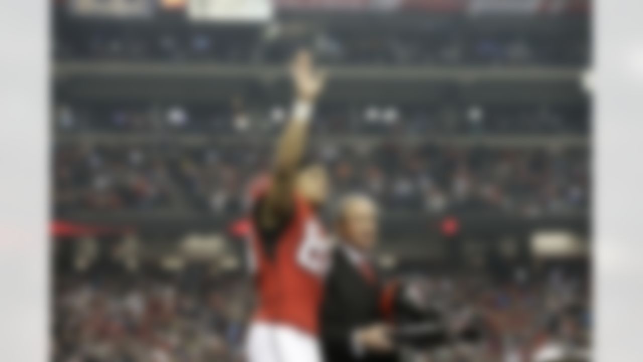 Atlanta Falcons tight end Tony Gonzalez waves to the crowd during a celebration of his career as Atlanta Falcons owner Arthur Blank looks on before the second half of an NFL football game against the Carolina Panthers, Sunday, Dec. 29, 2013, in Atlanta. (AP Photo/John Bazemore)