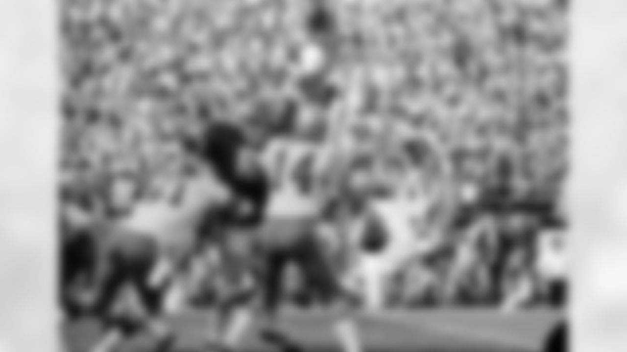 Dallas quarterback Craig Morton (14) just can't see his way clear to get rid of the ball as Kansas City's big Curley Culp comes in to break up the pass play in Kansas City, on Oct. 26, 1970. Dave Manders (51) attempts to hold back Culp. The Dallas Cowboys beat the Kansas City Chiefs, 27-16. (AP Photo/William P Straeter)