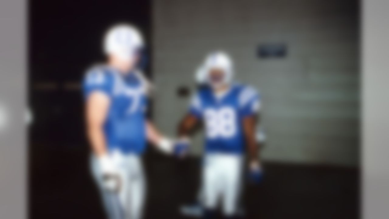 Indianapolis Colts tackle Adam Meadows (73) shakes hands with wide receiver Marvin Harrison (88) in the tunnel before an NFL game against the Minnesota Vikings in Indianapolis, on December 24, 2000. (AP Photo/Kevin Terrell)