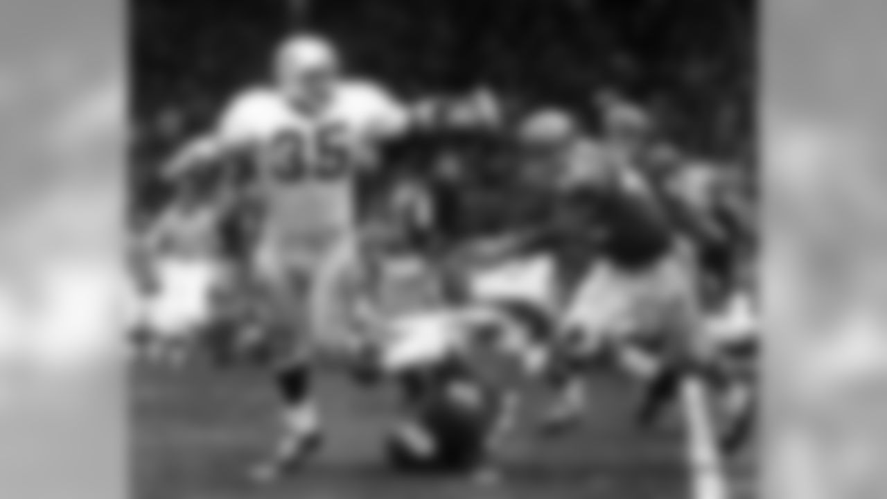 Oakland Raiders fullback Hewritt Dixon (35) is slowed down by Kansas City Chiefs linebacker Bobby Bell (78) as safety Johnny Robinson (42) zeroes in on him during a 27-24 Raiders victory on November 23, 1969, at Municipal Stadium in Kansas City, Missouri. (Rod Hanna/NFL)