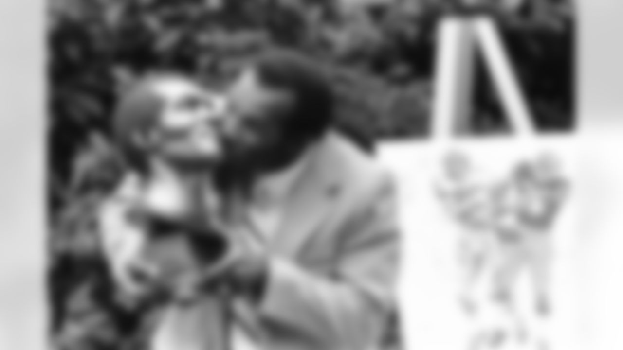 Former Green Bay Packers cornerback Herb Adderley hugs his statue after enshrinement in the Pro Football Hall of Fame in Canton, Ohio, Aug. 2, 1980. (Associated Press)