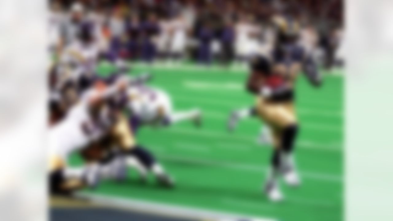 St. Louis Rams' running back Marshall Faulk (28) is untouched as he heads for the end zone to score during the first quarter against the Minnesota Viking at the Trans World Dome in St. Louis, Suinday, Dec. 10, 2000. Reaching out is the Vikings' Chris Hovan (99). Falk scored on a one-yard run for his second touchdown of the first quater. (AP Photo/James A. Finley)