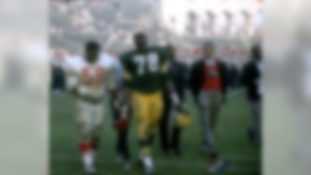Kansas City Chiefs defensive tackle Andrew Rice (58) walks off the field with Green Bay Packers defensive tackle Bob Brown (78) following Super Bowl I at the Los Angeles Memorial Coliseum on January 15, 1967. (National Football League)