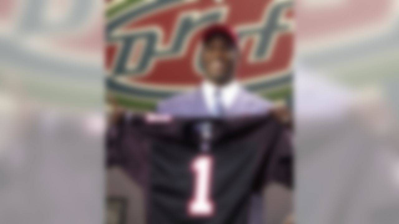 Quarterback Michael Vick of Virginia Tech holds up an Atlanta Falcons jersey after being picked No. 1 in the NFL draft Saturday, April 21, 2001 in New York. (AP Photo/Mark Lennihan)