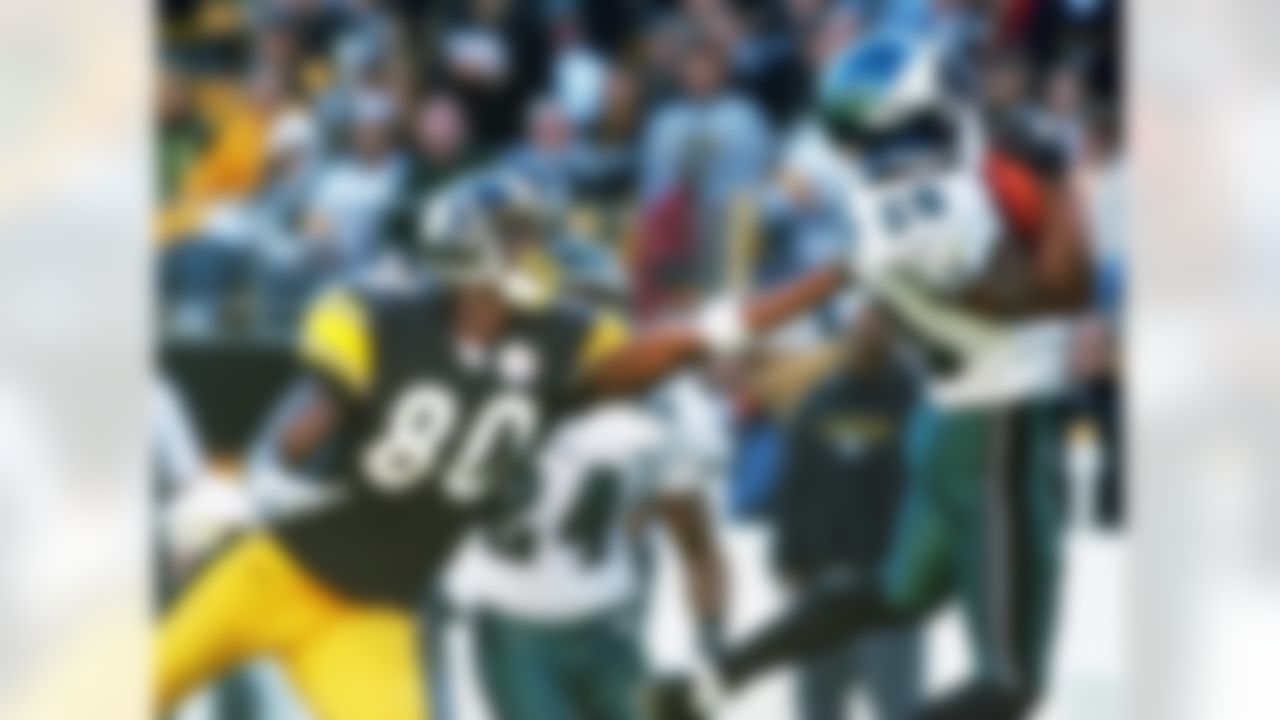 Philadelphia Eagles safety Brian Dawkins (20) intercepts a pass internded for Pittsburgh Steelers wide receiver Plaxico Burress (80) in the second quarter in Pittsburgh on Sunday, Nov. 7, 2004. Eagles cornerback Sheldon Brown (24) is in the center. (AP Photo/Keith Srakocic)