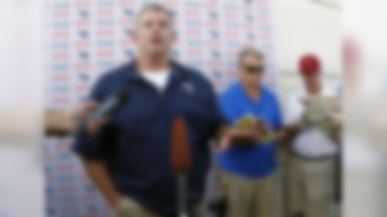 Tennessee Titan head coach Mike Munchak, left, speaks to reporters after NFL football training camp on Saturday, July 28, 2012, Nashville, Tenn. (AP Photo/Wade Payne)