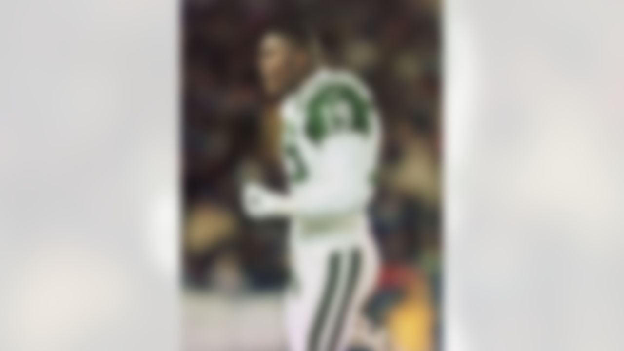 New York Jets wide receiver Keyshawn Johnson (19) pumps his fist as he walks off the field after catching a second quarter touchdown pass during their AFC East Conference game against the New England Patriots at Foxboro Stadium Monday night Nov. 15, 1999 in Foxboro, Mass.