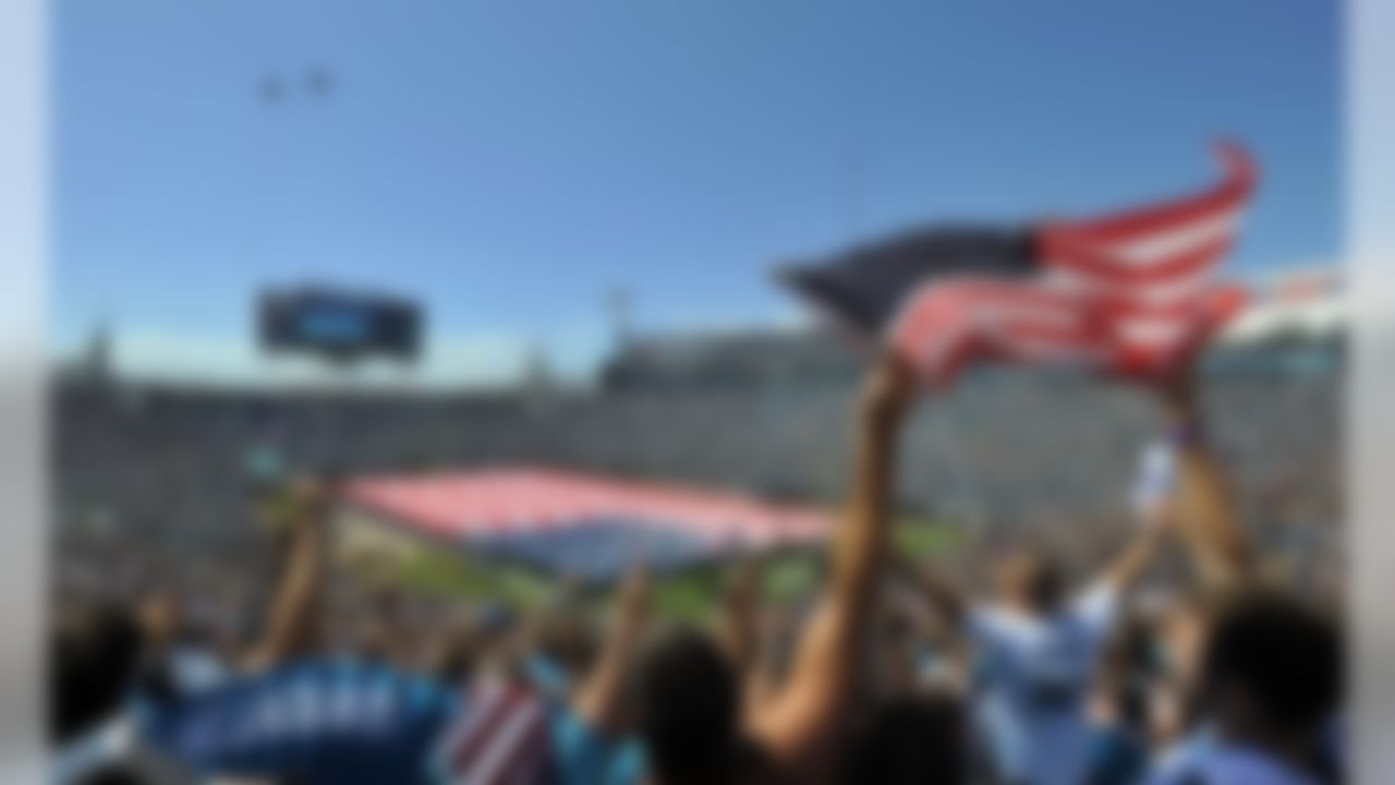 Jaguars fans wave flags and cheer as two military jets perform a fly over during 9/11 pregame ceremonies in Jacksonville.