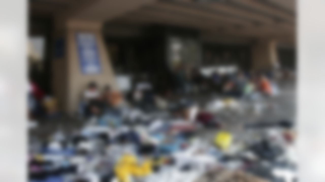Flood victims sit in chairs among trash outside the New Orleans Center next to the Superdome on Friday, Sept. 2, 2005. (AP Photo/Bill Haber)
