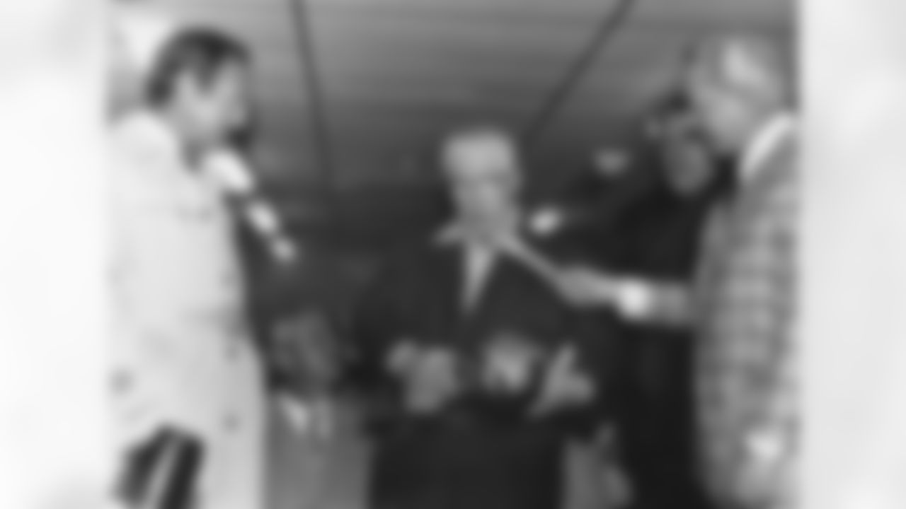 NFL commissioner Pete Rolzelle, Art Rooney Sr., Chairman of the board for the Pittsburgh Steelers, Steelers head coach Chuck Noll, and NBC announcer Charlie Jones together in the Steelers locker room as Rooney receives the Vince Lombardi trophy after his Super Bowl IX - Pittsburgh Steelers vs Minnesota Vikings - January 12, 1975. (Associated Press/NFL Photos)