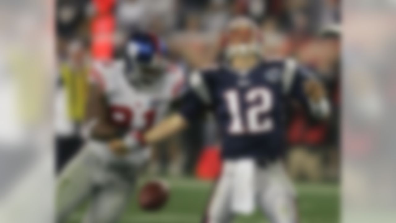 New York Giants defensive end Justin Tuck (91) strips the football from New England Patriots quarterback Tom Brady (12) during the second quarter of the Super Bowl XLII football game at University of Phoenix Stadium on Sunday, Feb. 3, 2008 in Glendale, Ariz. (AP Photo/Chris O'Meara)