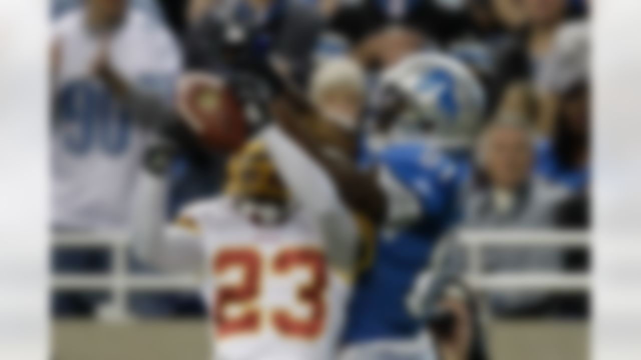 Washington Redskins cornerback DeAngelo Hall (23) intercepts a pass intended for Detroit Lions wide receiver Calvin Johnson (81) in the first quarter of their NFL football game in Detroit, Sunday, Oct. 31, 2010.