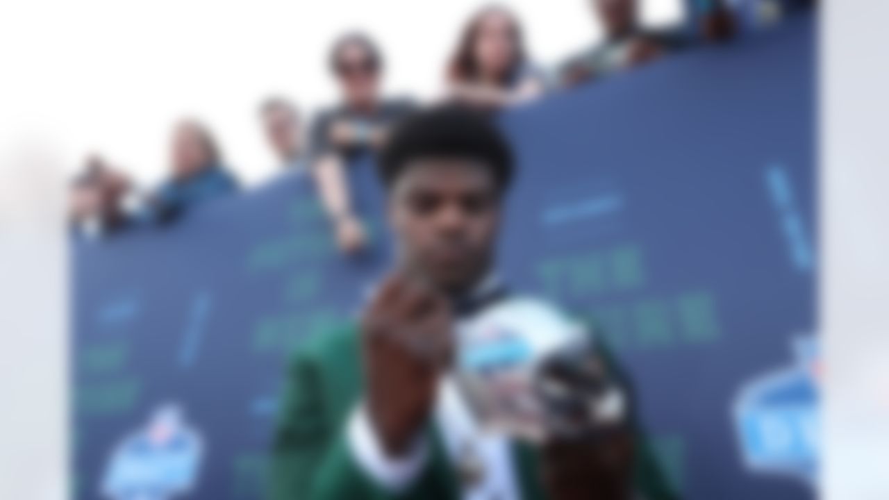 Louisville quarterback Lamar Jackson signs autographs for fans.