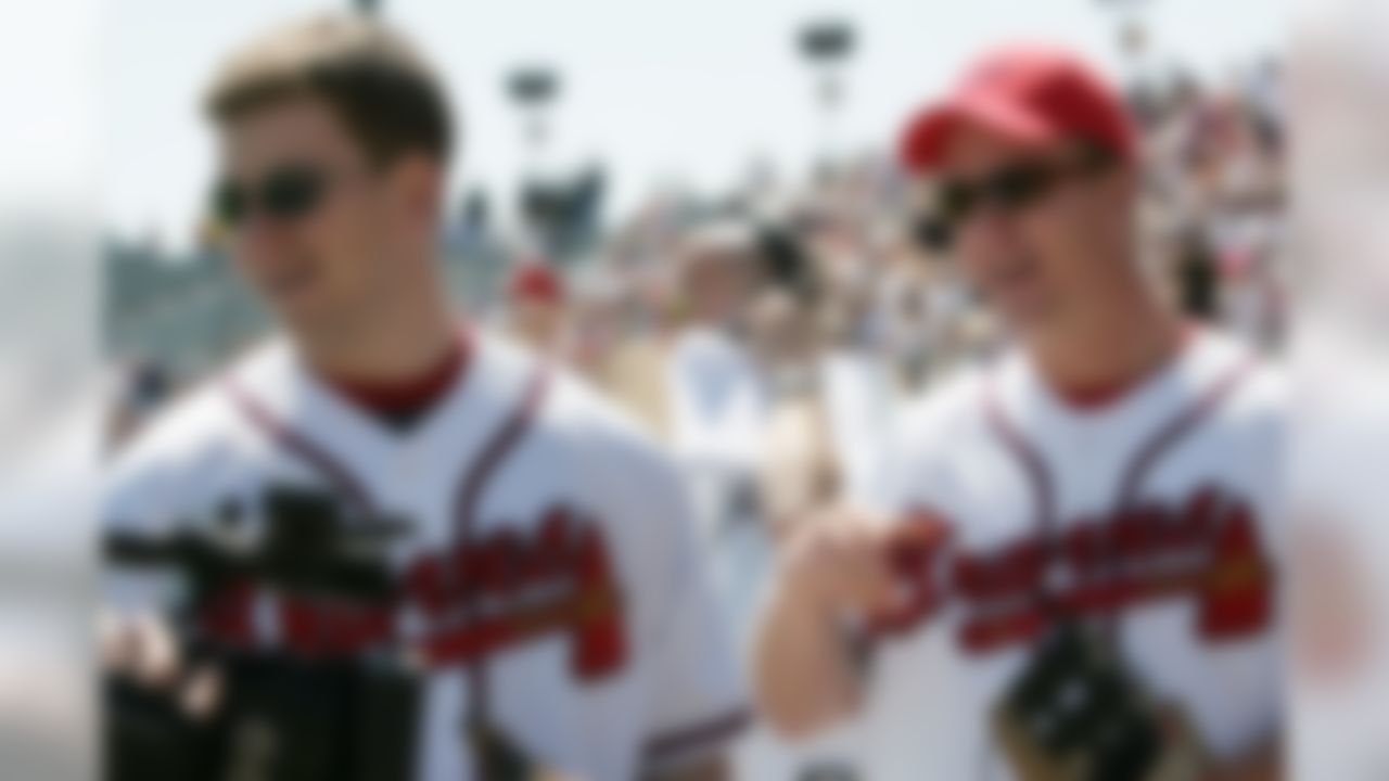 Denver Broncos quarterback Peyton Manning, right, and his brother, New York Giants quarterback Eli Manning, left, wait to throw out the first pitch before the start of the Atlanta Braves game against the Pittsburgh Pirates on Thursday, March 10, 2005 in Kissimmee, Fla. (AP Photo/David J. Phillip)