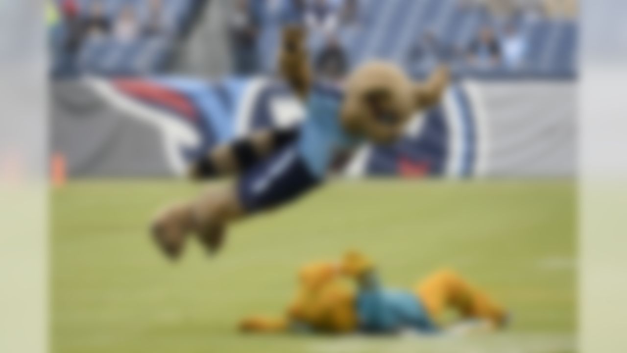 The Tennessee Titans mascot dives on a Jacksonville Jaguars mascot. (Mark Zaleski/Associated Press)