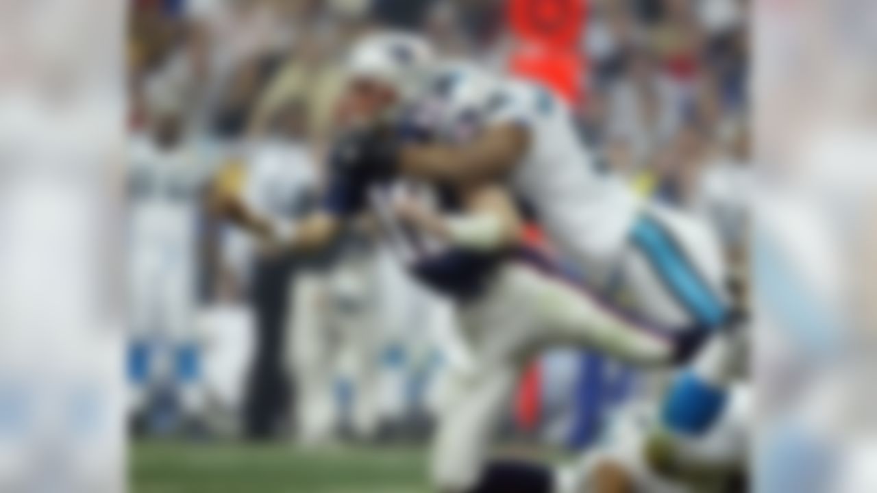 New England Patriots quarterback and game MVP Tom Brady (12) is hit during Super Bowl XXXVIII against the Carolina Panthers at the Reliant Stadium in Houston, TX Sunday Feb. 1, 2004. (AP Photo/Greg Trott)