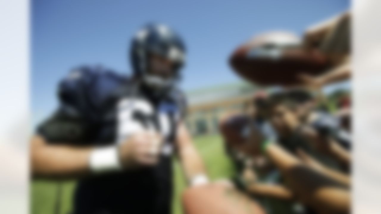 Seattle Seahawks' Max Unger signs autographs on Friday, Aug. 3, 2012, during NFL football training camp in Renton, Wash. (AP Photo/Ted S. Warren)