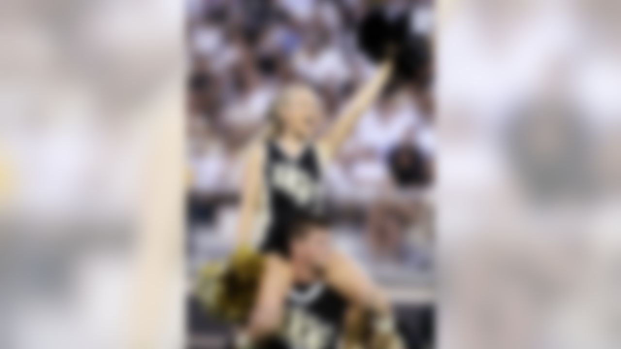 Central Florida cheerleaders lead the team onto the field during an NCAA college football game between Central Florida and Charleston Southern on Saturday, Sept. 03, 2011, in Orlando, Fla.  UCF won 62-0. (AP Photo/Reinhold Matay)