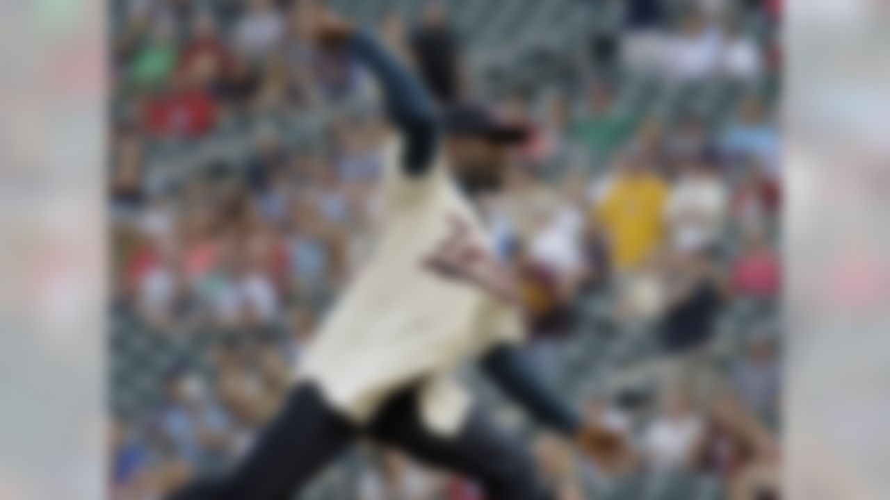 Greg Jennings, the Minnesota Vikings' newest wide receiver, throws out the ceremonial first pitch before the Milwaukee Brewers and the Minnesota Twins baseball game on Wednesday, May 29, 2013, in Minneapolis. (AP Photo/Tom Olmscheid)