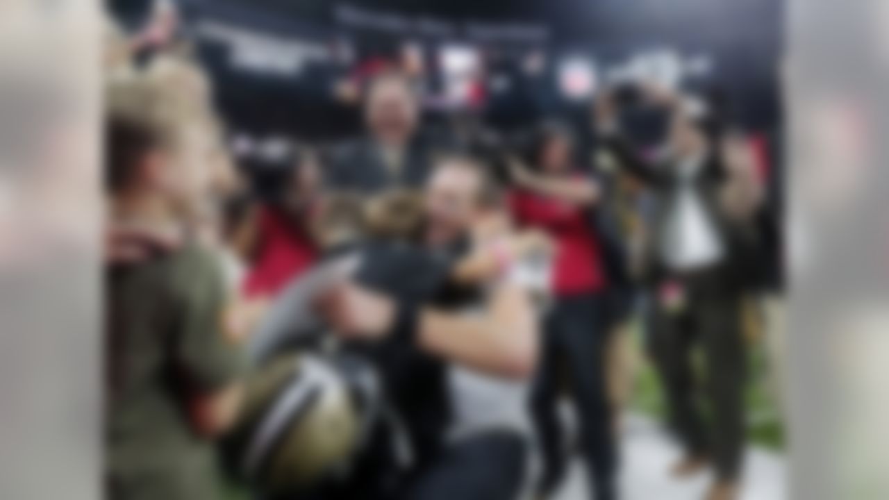 New Orleans Saints quarterback Drew Brees (9) hugs his family after breaking the NFL all-time passing record in the first half of an NFL football game against the Washington Redskins in New Orleans, Monday, Oct. 8, 2018.